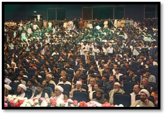 Large crowd in an auditorium setting.